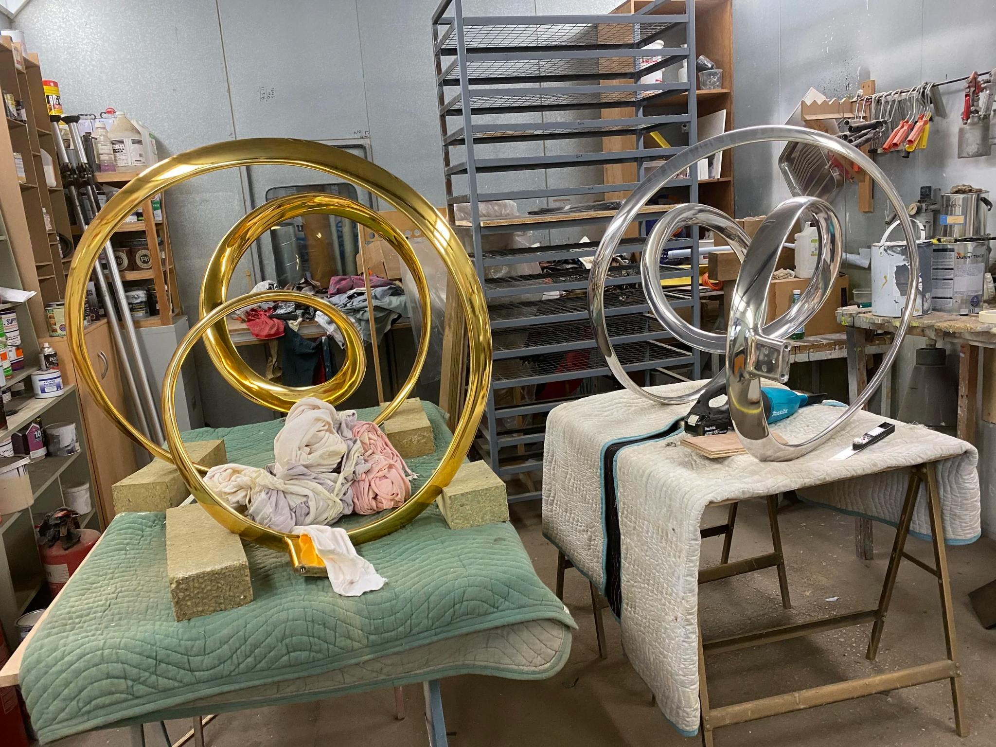 Gold and silver Giant Bronze Wonder sculptures together in the workshop
